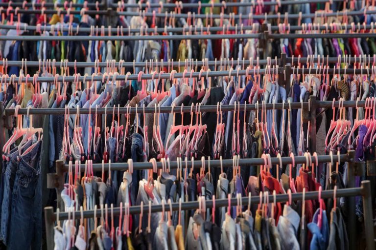 Mass of clothes hanging on racks