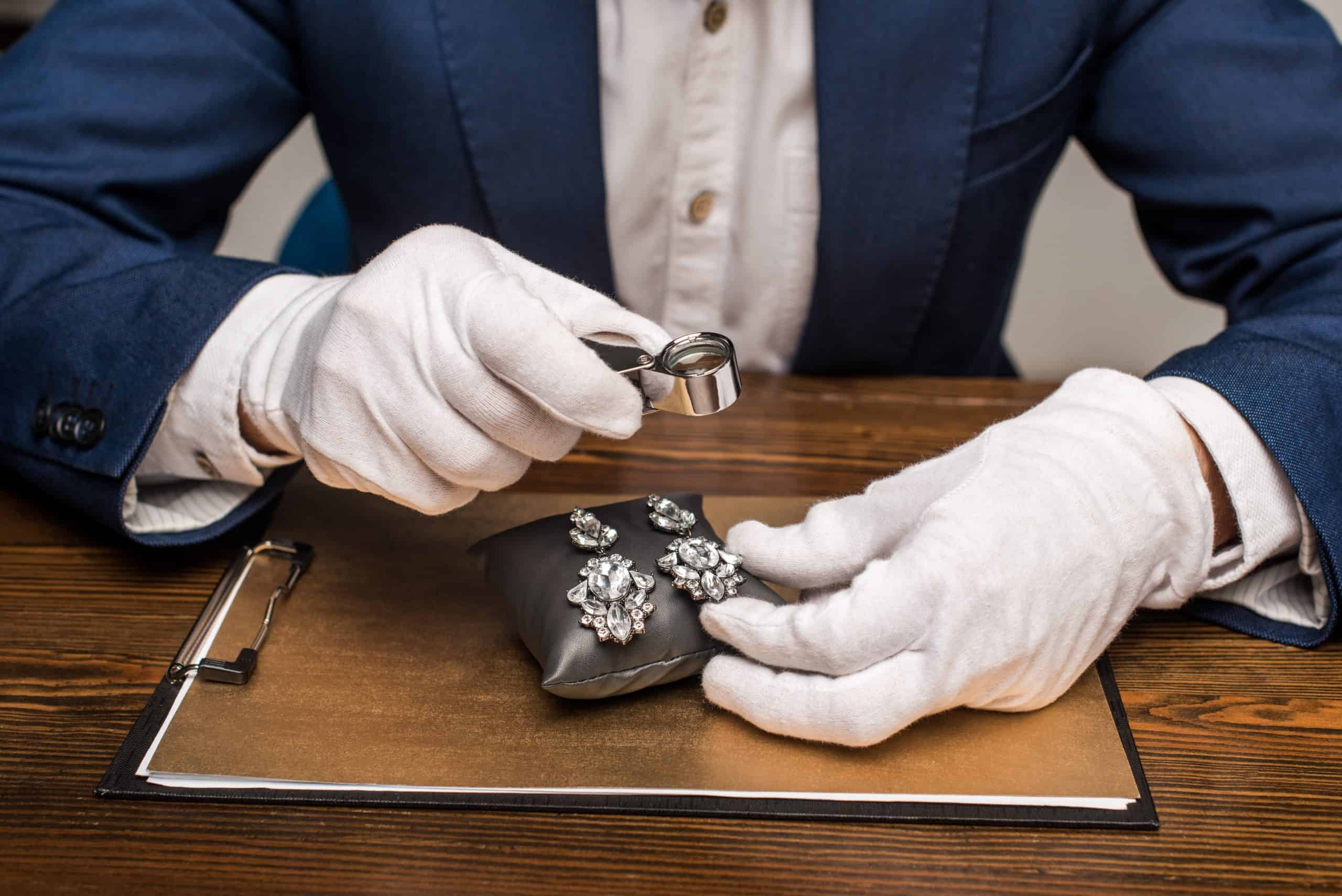 Jewellery appraiser holding magnifying glass