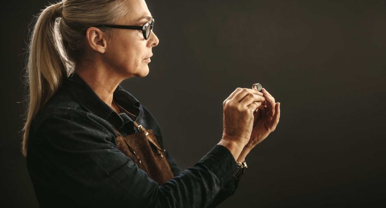 Goldsmith examining a ring for flaws.