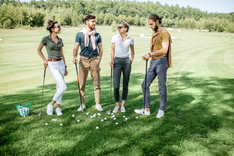 Friends standing together on a golf course.